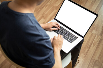A man wear blue T-Shirt using Laptop Black screen mock up