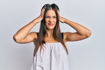 Young hispanic woman wearing casual clothes suffering from headache desperate and stressed because pain and migraine. hands on head.