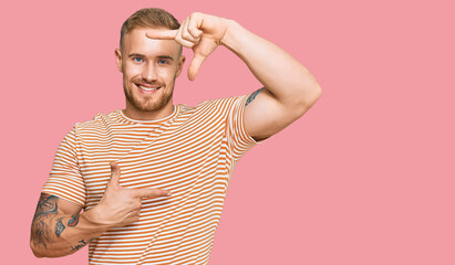 Young irish man wearing casual clothes smiling making frame with hands and fingers with happy face. creativity and photography concept.