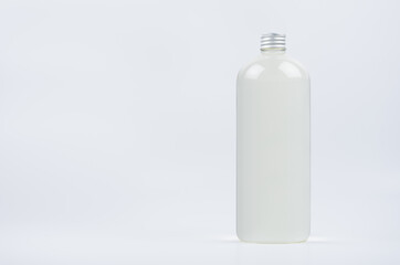 Transparent plastic tall bottle with water, silver cap mockup on white background. Template for portfolio, design, branding identity.