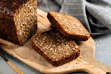 Closeup on sliced rye whole grain bread with seeds on the wooden board