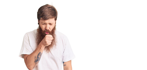 Handsome young red head man with long beard wearing casual white tshirt feeling unwell and coughing...