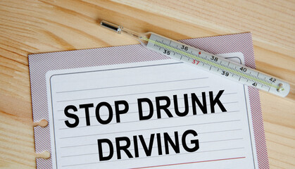 On the sheets from the diary text STOP DRUNK DRIVING, next to the thermometer.