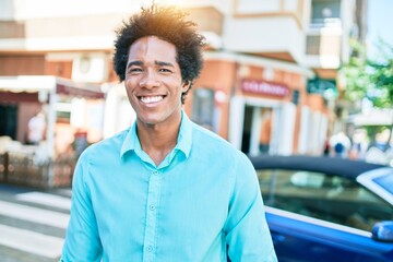 Young handsome african american man wearing casual clothes smiling happy. Standing with smile on face walking at town street.