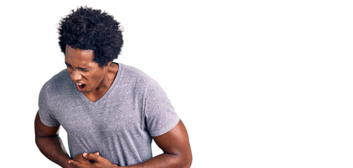 Handsome african american man with afro hair wearing casual clothes with hand on stomach because...