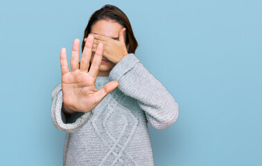 Young caucasian girl wearing casual clothes covering eyes with hands and doing stop gesture with...