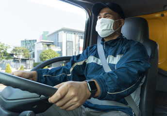 young Asian man wearing a protective mask is driving a car