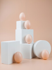 Chicken Eggs on a white podium or pedestal. Food minimalism concept still life.