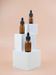 Brown glass bottles with serum, essential oil or other cosmetic product. Natural organic cosmetic packaging, skin care concept.