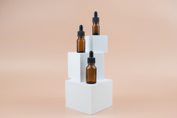 Brown glass bottles with serum, essential oil or other cosmetic product. Natural organic cosmetic packaging, skin care concept.