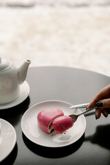 Heart-shaped slice of mousse cake in a fork. Valentine's day february 14. Festive desserts.