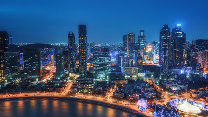 Fototapeta na wymiar Night view of modern city buildings in Qingdao, China