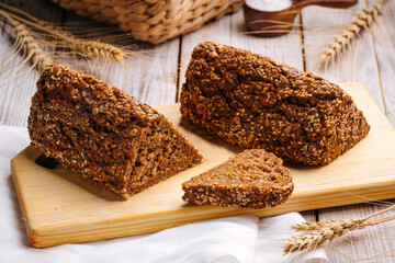 Side on sliced triangle flourless diet grain bread on wooden board