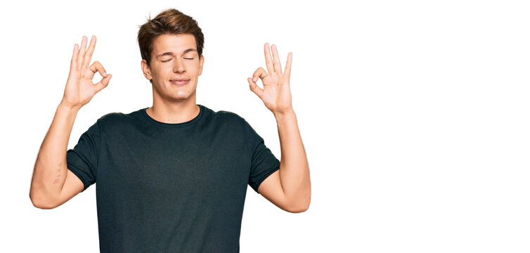 Handsome caucasian man wearing casual clothes relax and smiling with eyes closed doing meditation gesture with fingers. yoga concept.