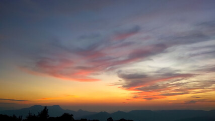 Fototapeta na wymiar Orange red coloured sunset in the mountains