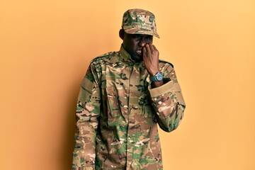 Young african american man wearing army uniform looking stressed and nervous with hands on mouth biting nails. anxiety problem.