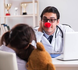 Funny pediatrician with little girl at regular check-up