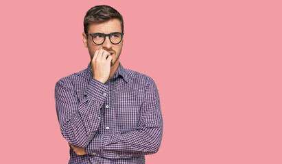 Handsome caucasian man wearing casual clothes and glasses looking stressed and nervous with hands on mouth biting nails. anxiety problem.