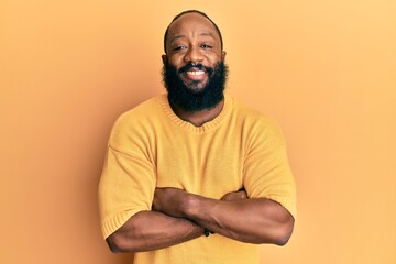 Obraz premium Young african american man wearing casual clothes happy face smiling with crossed arms looking at the camera. positive person.