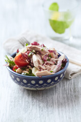  Salad with tuna, tomatoes and cucumber. Wooden background. Close up.