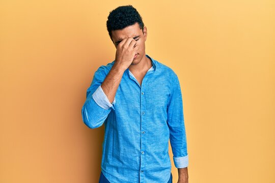 Young arab man wearing casual clothes tired rubbing nose and eyes feeling fatigue and headache. stress and frustration concept.