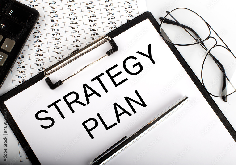 Poster paper with strategy plan on a table with chart