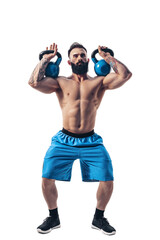 Muscular shirtless tattooed bearded male athlete bodybuilder workout with kettlebell on a white background. Isolate