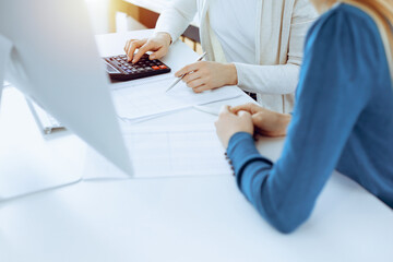 Accountant checking financial statement or counting by calculator income for tax form, hands...