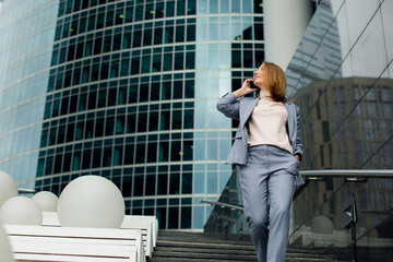 business girl talking on the phone at office building in the city