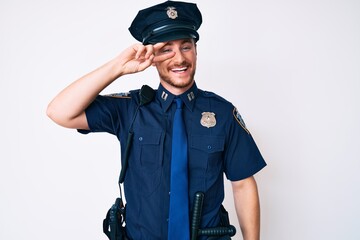 Young caucasian man wearing police uniform doing peace symbol with fingers over face, smiling...
