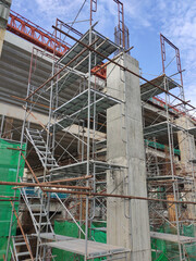 SHAH ALAM, MALAYSIA -AUGUST 8, 2020: Temporary staircase and falsework are used as the temporary support during construction. It is wrapped with safety netting for safety purposes. Installed by worker