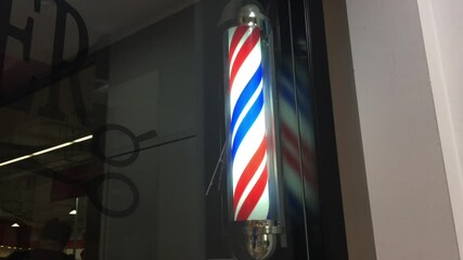 Barber shop pole sign spinning around.