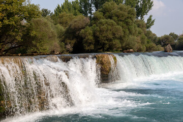 Big waterfall in the forest and empty blue sky