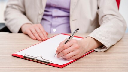 Hands taking notes in the pad
