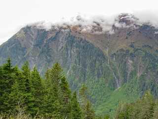 View of streams of water running down a mountain in Juneau, Alaska from the melting snow in the summer.