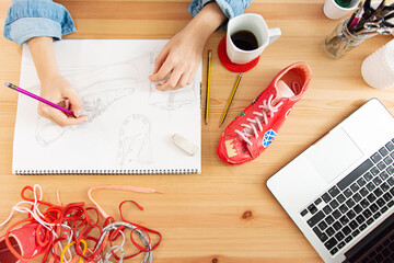 Fashion designer sketching sneakers for eco fashion customization upcycling project