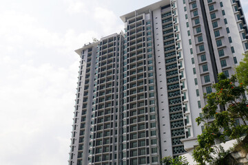 Fototapeta na wymiar SELANGOR, MALAYSIA -JULY 22, 2020: High rise apartment building with modern facade design. Popular in the urban areas in Malaysia. Various facilities for the use of the residents are provided.