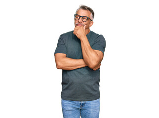 Middle age grey-haired man wearing casual clothes and glasses serious face thinking about question...