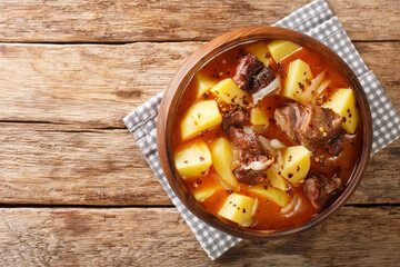 Bonava Mauritanian Lamb stew with potatoes in hot sauce close-up in a bowl on the table. Horizontal top view from above