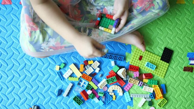Top view of child playing block toy
