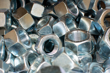 Shining wheel mounting nuts car, tractor, truck, heavy machinery close up. Industrial background.
