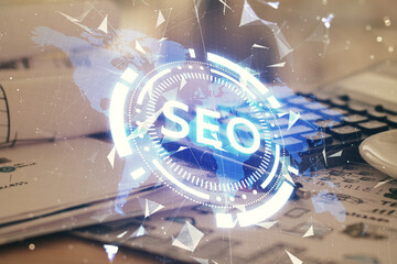 Multi exposure of SEO drawings and desk with open notebook background. Concept of Search...