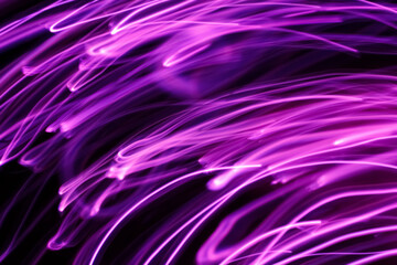 Long exposure pink lights abstract texture background. Pink lights drawing patterns on black background.