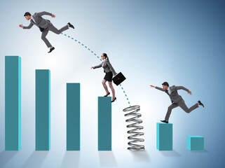 Business people jumping over bar charts