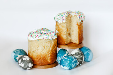 Easter composition with orthodox sweet bread, kulich and eggs on light background. Easter holidays breakfast