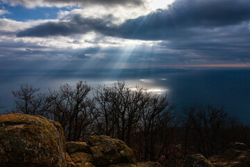 the sun rays break through the clouds and fall on the sea