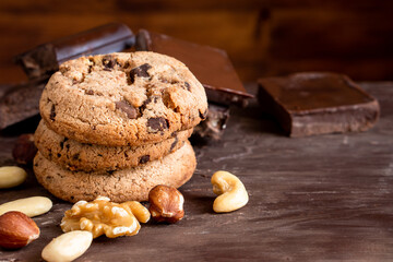 Organic food snack tasty sweet dessert milk dark chocolate chip salt cookie closeup piece fruit orange raspberry hazelnut nuts cinnamon on cocoa cacao powder wooden table for new year Christmas gift