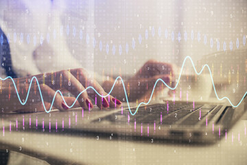 Multi exposure of woman hands typing on computer and financial graph hologram drawing. Stock market...