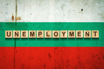 Unemployment. The inscription on wooden blocks on the background of the Bulgaria flag. Unemployment growth. Business. J