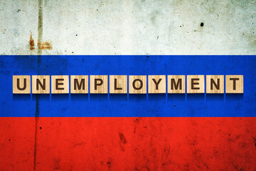 Unemployment. The inscription on wooden blocks on the background of the Russian flag. Unemployment growth. Business.